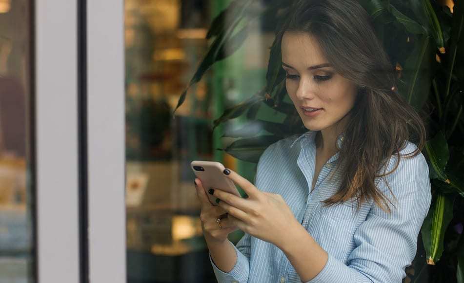 location-based searches - Woman using mobile phone