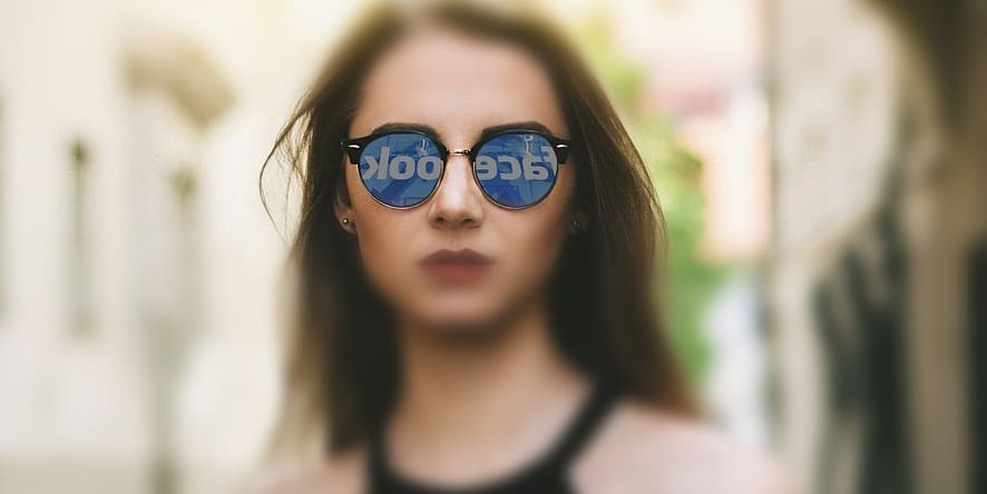 Facebook AR Glasses - Woman wearing sunglasses - facebook logo reflection