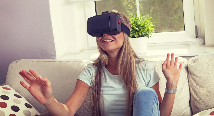 Virtual reality shopping - young woman on couch with VR headset