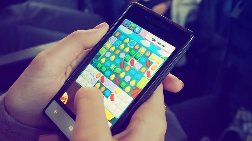 Mobile game revenue - person playing game on smartphone