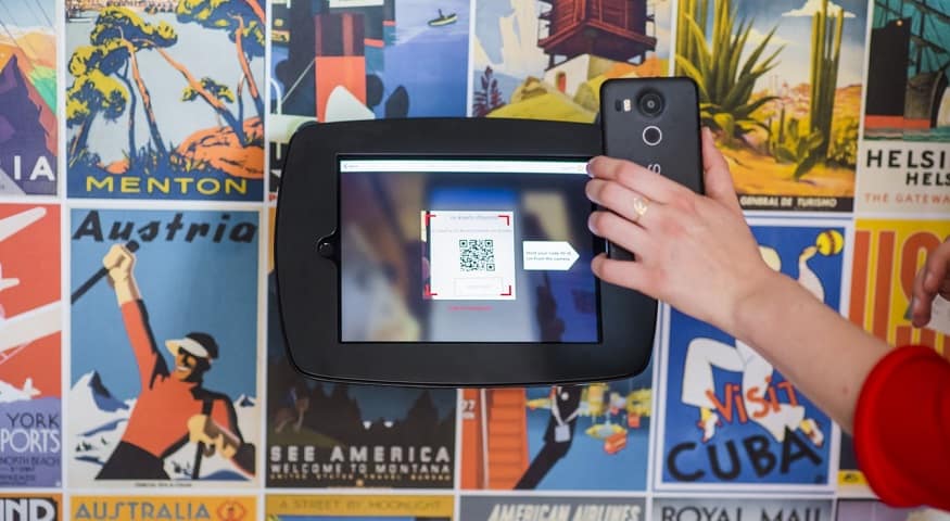 Use of QR Codes - person scanning QR code with mobile phone