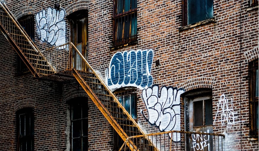 QR code signs - rundown building with graffiti