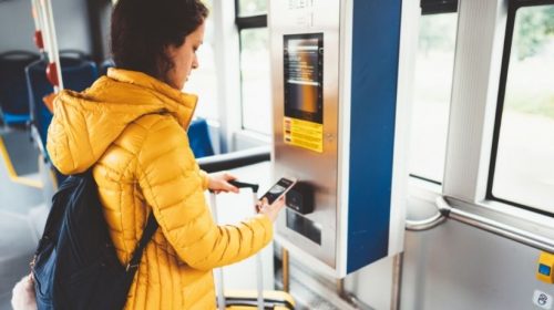 NFC ticketing - Person using phone on public transit