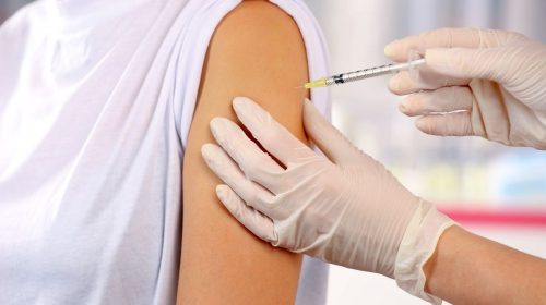 Vaccine patch - person receiving vaccine via needle