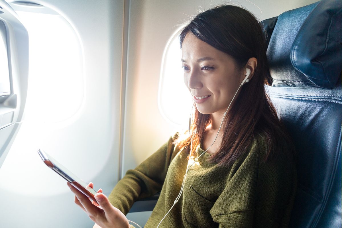 Mobile devices - person using device on plane