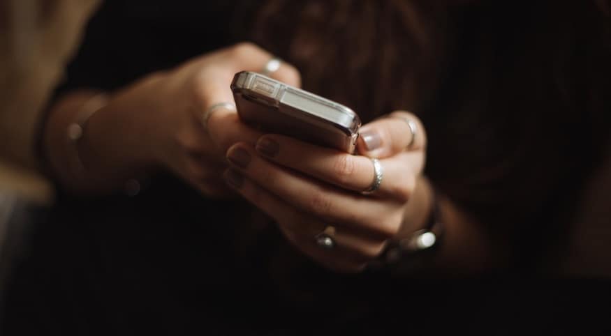 mobile commerce gains - woman using mobile phone