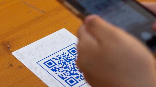 Contactless QR codes - Person scanning QR code with smartphone