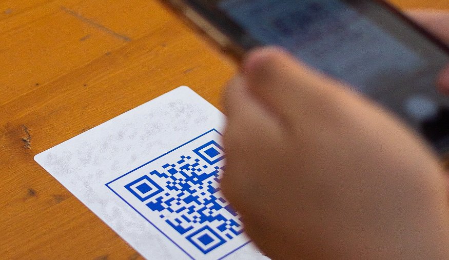 Contactless QR codes - Person scanning QR code with smartphone