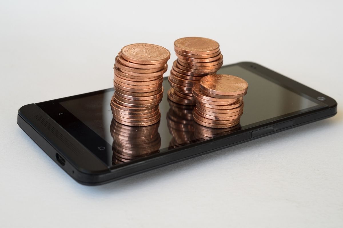 Mobile commerce sales - pennies on top of phone