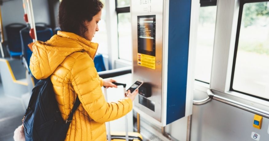 NFC ticketing - Person using phone on public transit