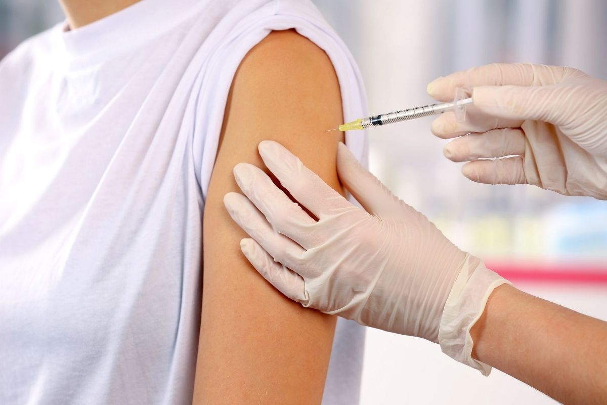 Vaccine patch - person receiving vaccine via needle