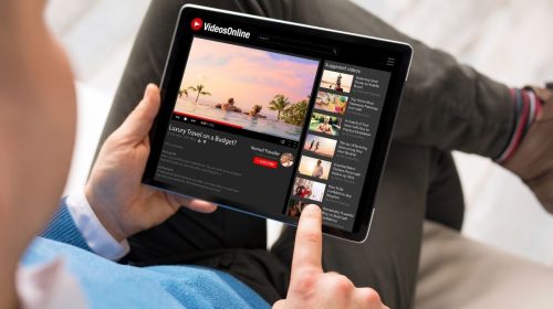YouTube Mobile App - Person using YouTube on tablet
