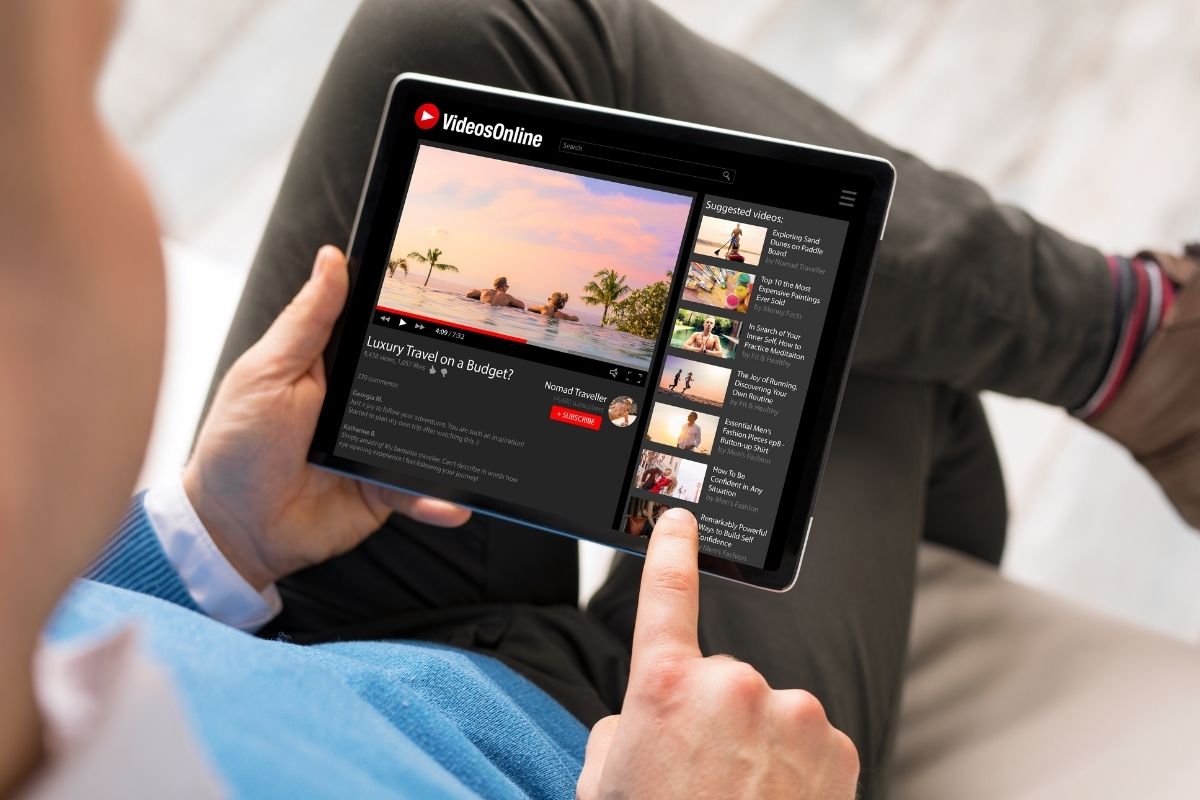 YouTube Mobile App - Person using YouTube on tablet