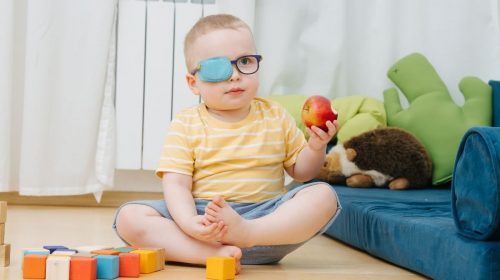 Virtual reality technology - child wearing patch for lazy eye