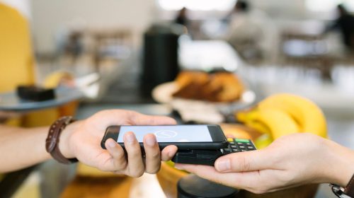 Mobile payments - Person paying with mobile phone