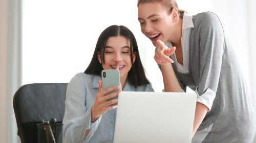 Technology trends - Young Women using mobile phone and laptop