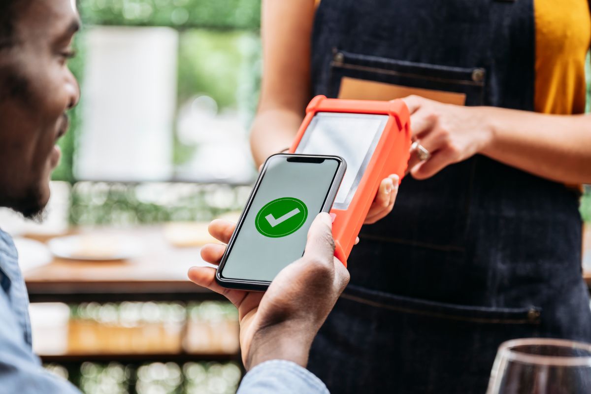 Mobile payments - Man paying by mobile phone