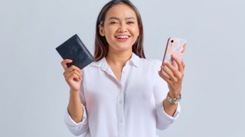 Mobile wallets - Millennial holding wallet and phone