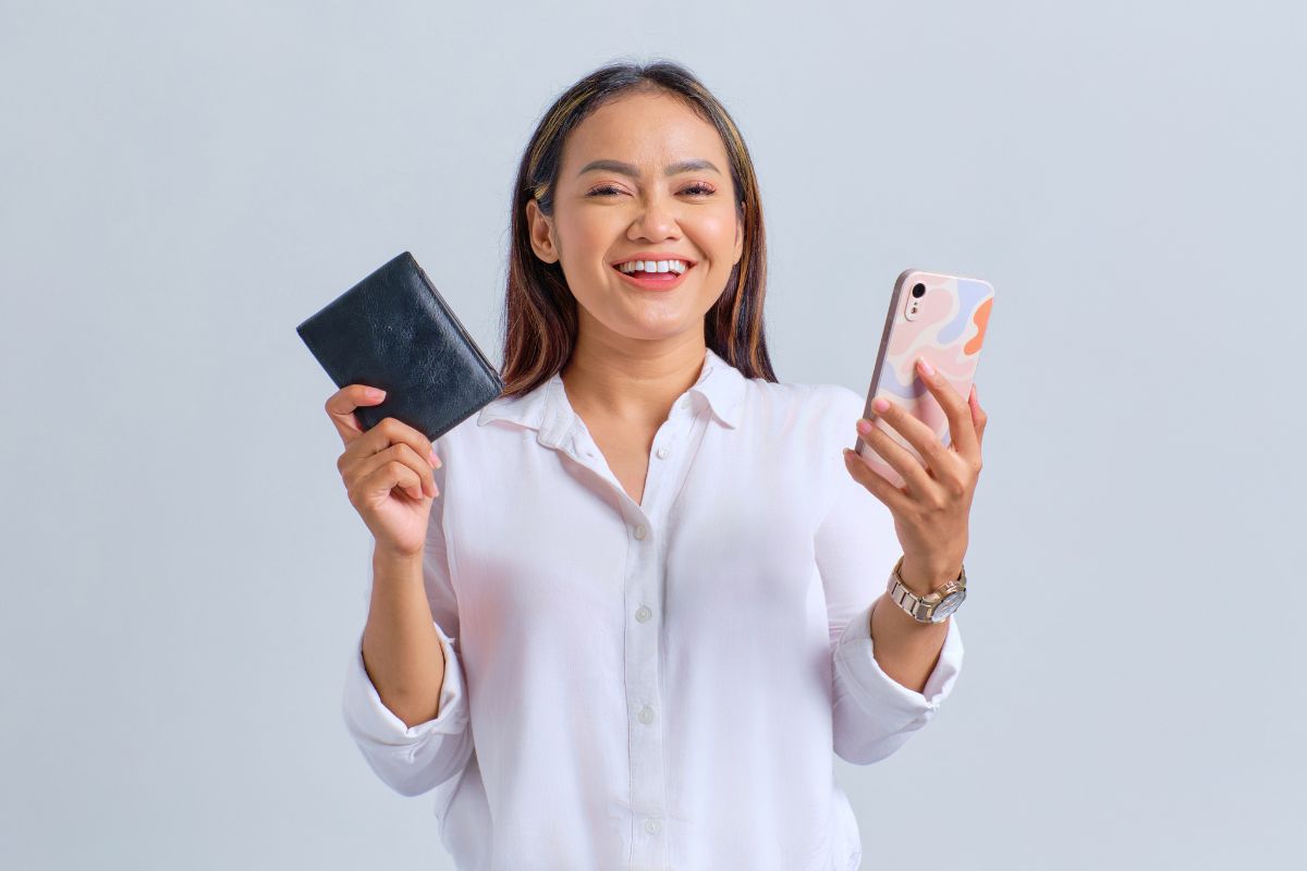 Mobile wallets - Millennial holding wallet and phone