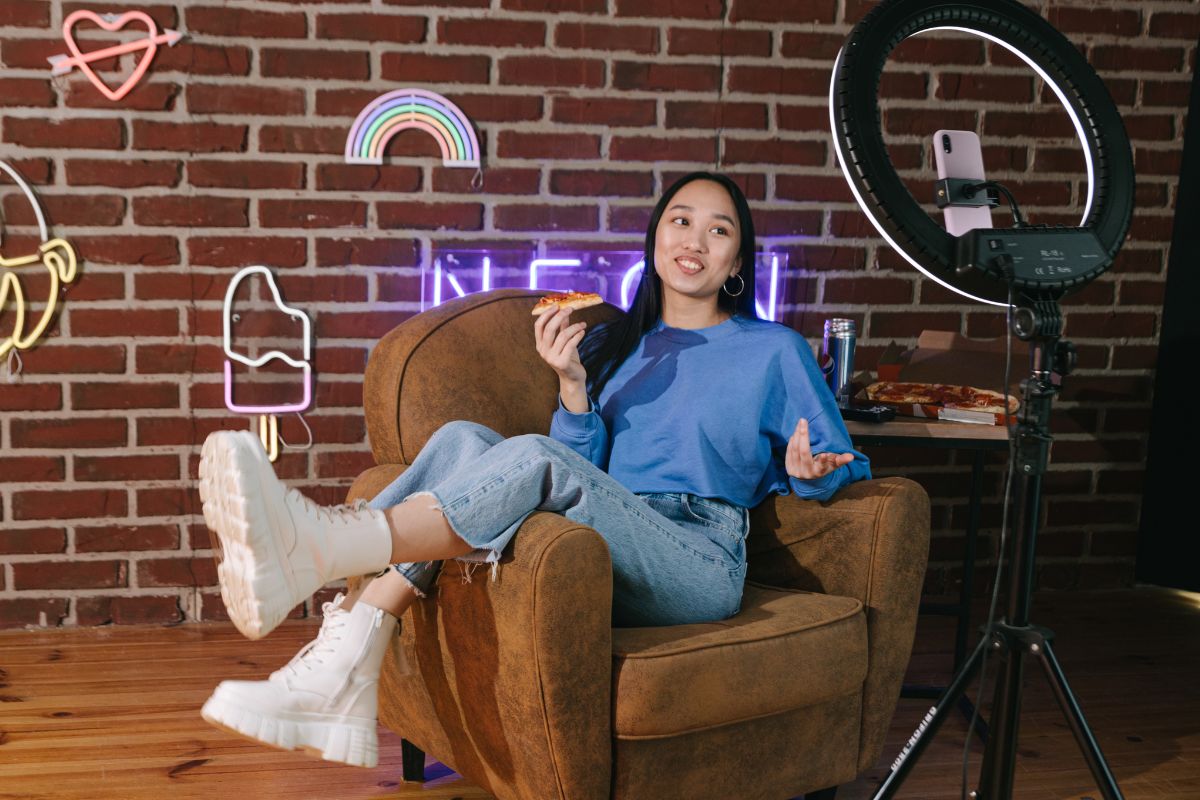 Social media influencer - Woman on couch in front of phone camera
