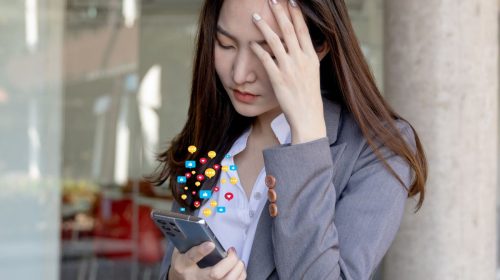 Mobile devices - Person looking stressed at mobile phone
