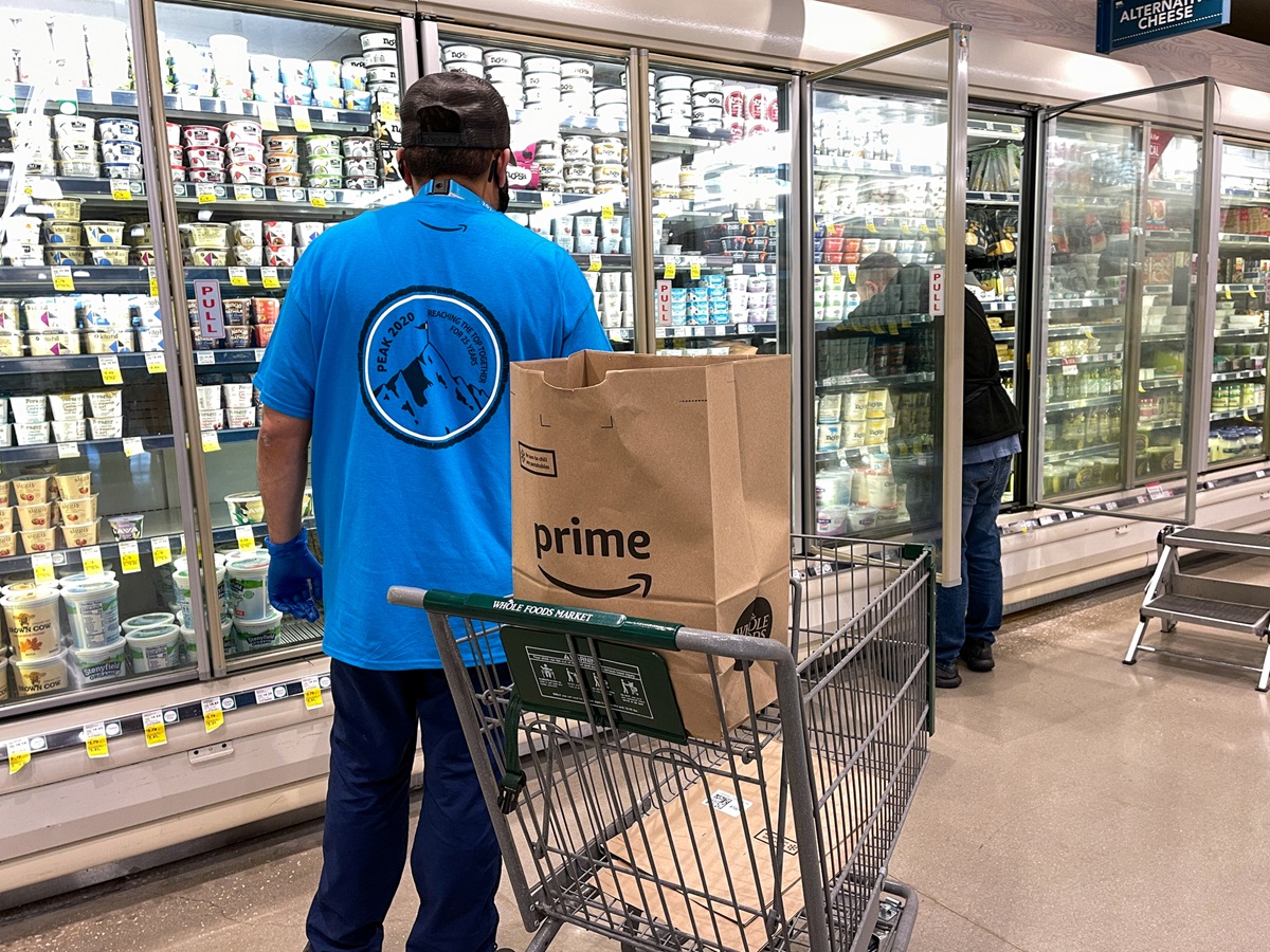 mobile commerce - person shopping in grocery store with Amazon Prime Bag